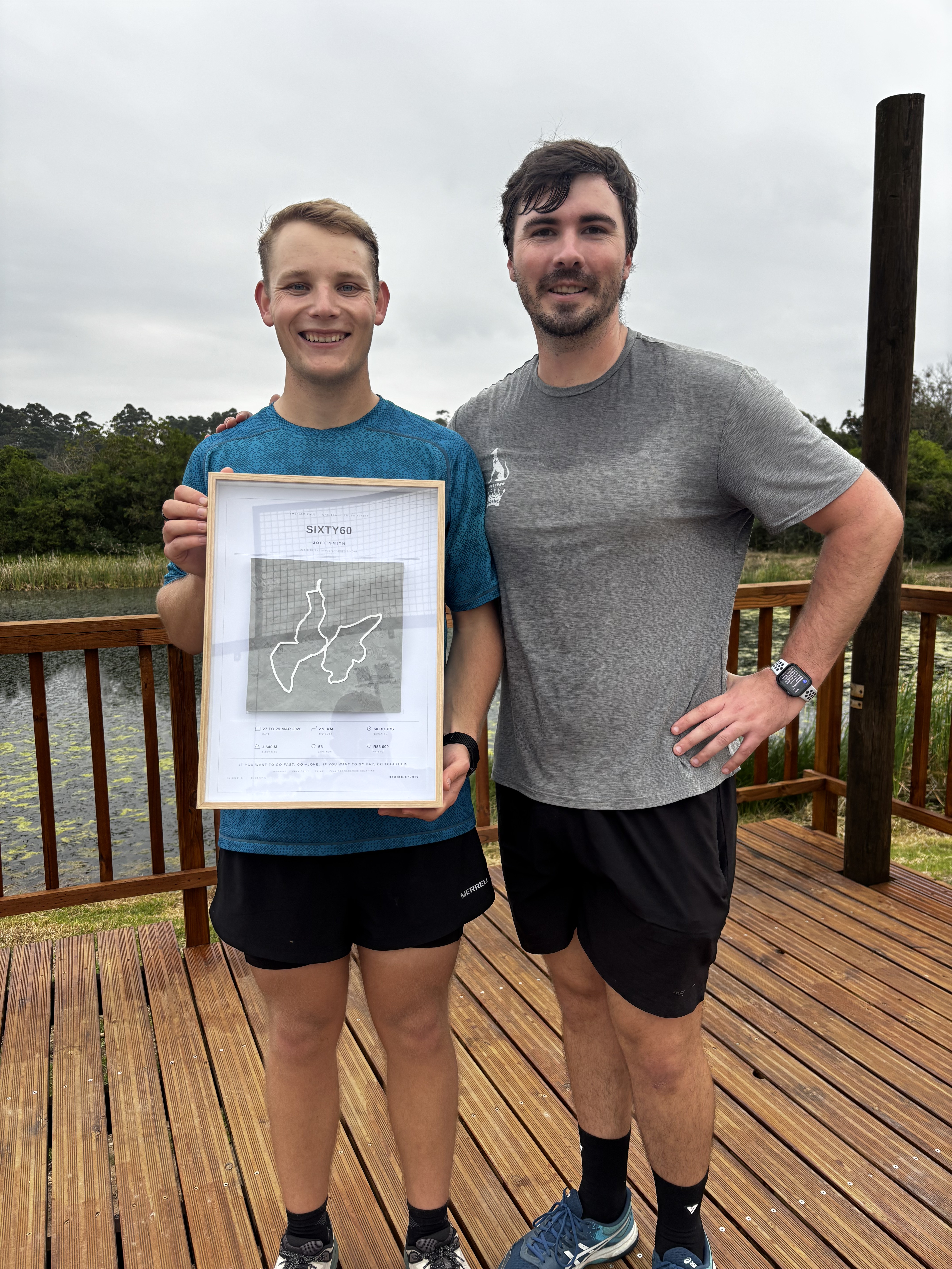 Joel Smith holding his framed Joel's Sixty60 fundraising display for the Kings Children's Home