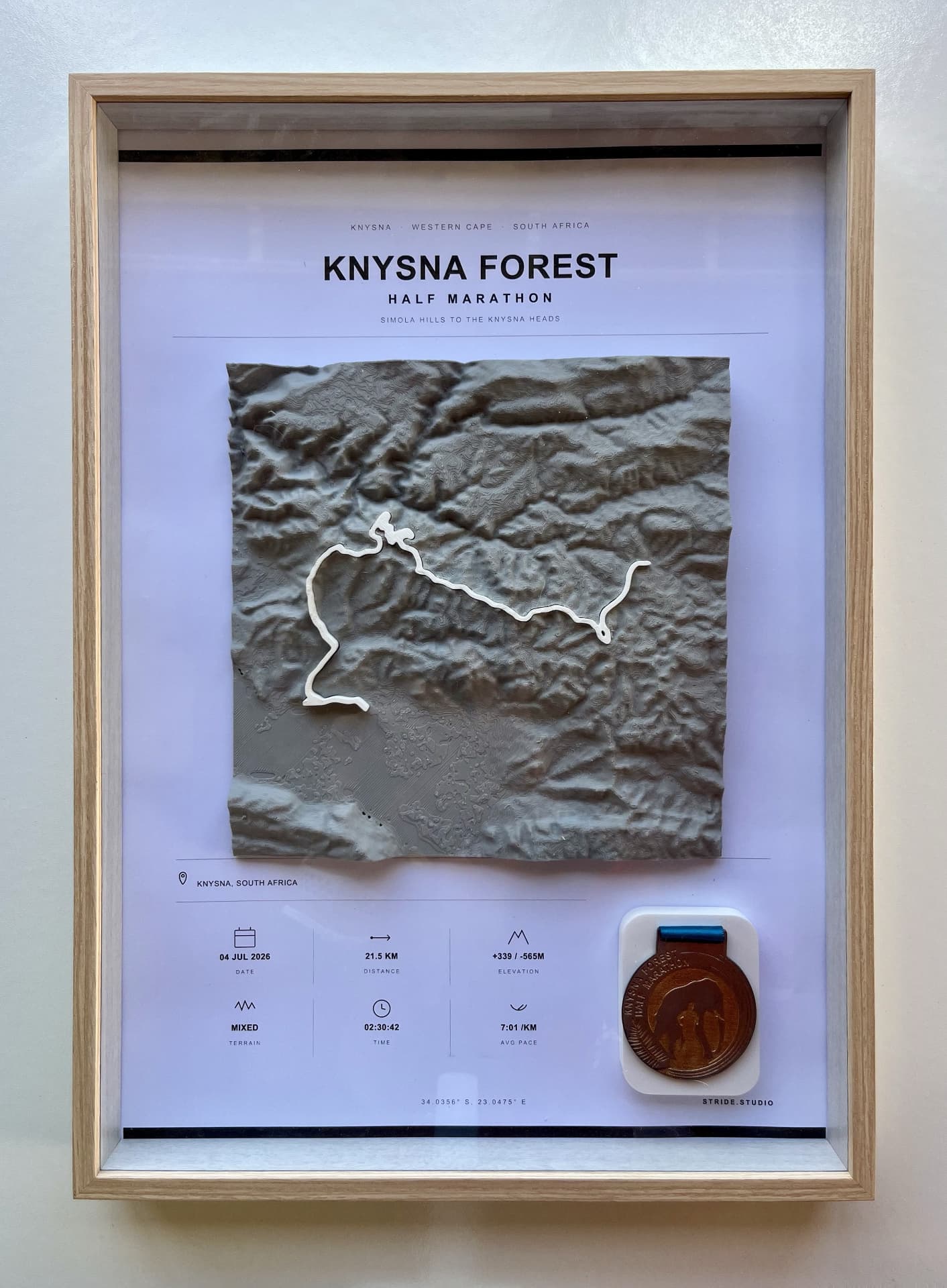 Framed Knysna Forest Half Marathon 3D route relief with finisher medal in an oak shadow box